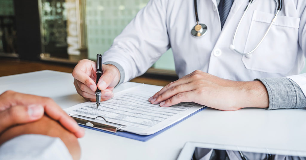 Physician/doctor writing a prescription for a patient